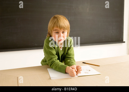Boy leaning on a table Stock Photo