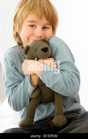 Portrait of a boy holding a teddy bear Stock Photo - Alamy