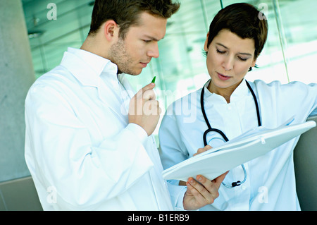 Close-up of two doctors discussing a medical record Stock Photo