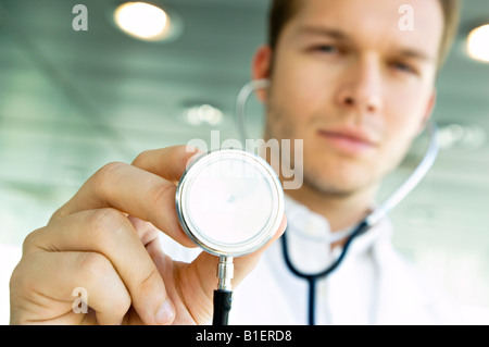 Close-up of a male doctor holding stethoscope in the office Stock Photo ...