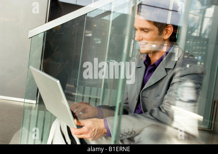 Businessman sitting on a staircase and using a laptop Stock Photo