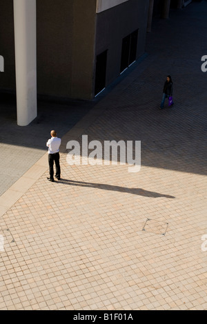 An office worker standing in the sunshine, London, UK Stock Photo