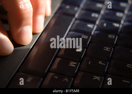 Fingers on a laptop' s keyboard Stock Photo