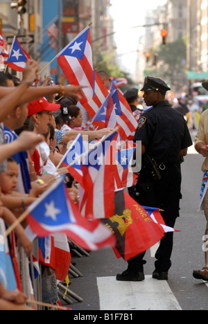 Police watch spectators at the 13th Annual National Puerto Rican Day Parade in New York on Fifth Avenue Stock Photo