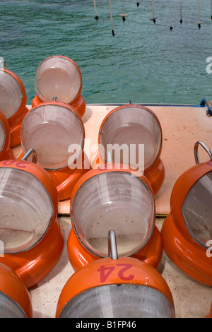 Red helmets used during underwater walks as breathing apparatus air is pumped into them via tube. Stock Photo