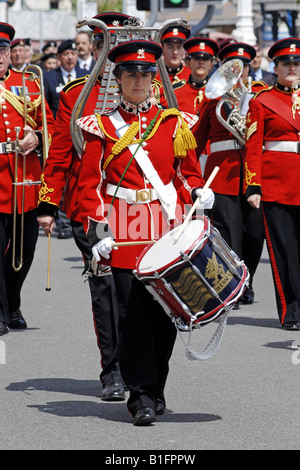 Drummers of the British Army in cerimonial Red tunics march through the streets of Weymouth at a Welcome Home Parade Stock Photo