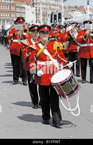 Drummers of the British Army in cerimonial Red tunics march through the streets of Weymouth at a Welcome Home Parade Stock Photo