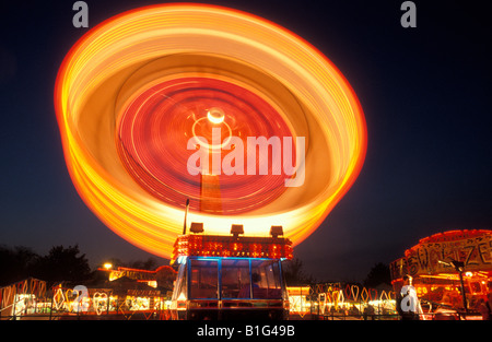 Fairground Ride spinning at night England UK Stock Photo