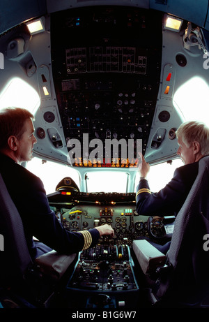 Finnair pilots in the cockpit of a commercial jet airplane Stock Photo