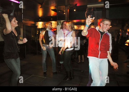 group of teenage boys and girls dancing at night club Stock Photo