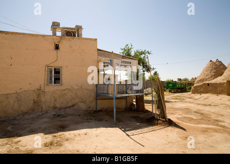 Traditional mudbrick 'beehive' houses and the shop in the  ancient Mespotamian city of Harran, South Eastern Turkey Stock Photo