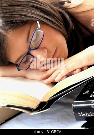 A young woman sleeping with books Stock Photo