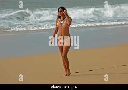 Young lady walking on beach in Hawaii Stock Photo