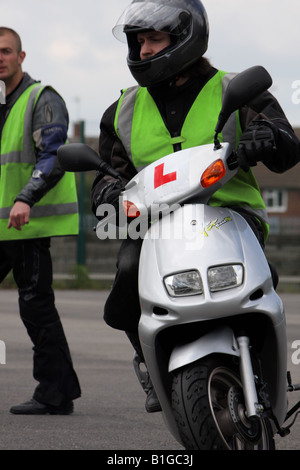 A young male on his cbt with the instructor in the background Stock Photo