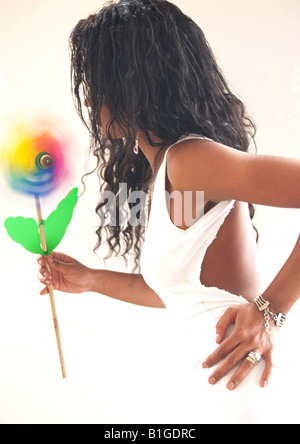 Side view of a woman holding pinwheel Stock Photo