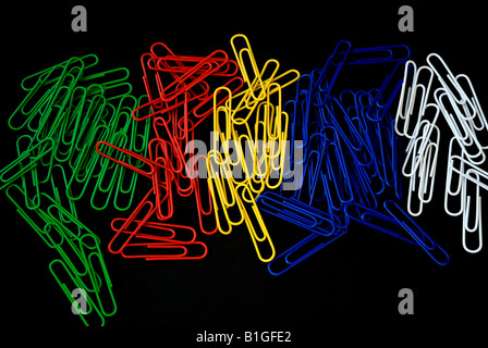 Muilti coloured paper clips on black paper background Stock Photo
