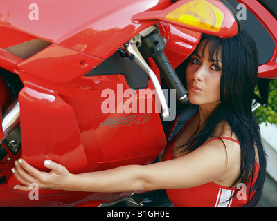 A young woman lying on motorbike Stock Photo