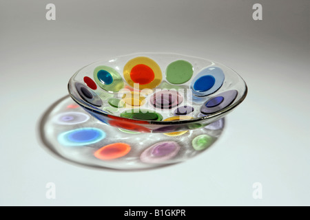 coloured glass plate with circles of colour on it. Light shining from above Stock Photo