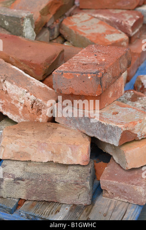 Old red clay bricks at a reclamation yard salvage building material Stock Photo