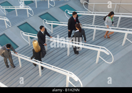 Business people moving up and down stairs, elevated view Stock Photo