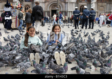 two-year girl feeding pigeons in the city street Stock Photo - Alamy