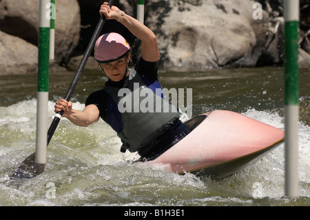 Young woman whitewater kayaking Stock Photo