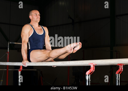 Gymnast on parallel bars Stock Photo