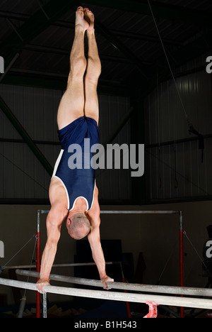 Gymnast doing handstand on parallel bars Stock Photo