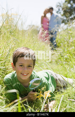 A boy holding a magnifying glass Stock Photo