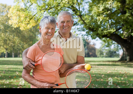 Senior couple playing badminton Stock Photo