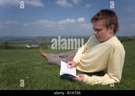 Man reading book outside Stock Photo