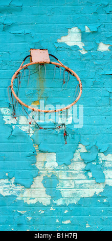Old Broken Basketball Hoop With Peeling Paint On Wall Stock Photo