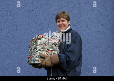 Council employee holding recycled metal trash, refuse, crushed, garbage, beverage Aluminium cans crushed into a cube, Blairgowrie, Scotland, UK Stock Photo