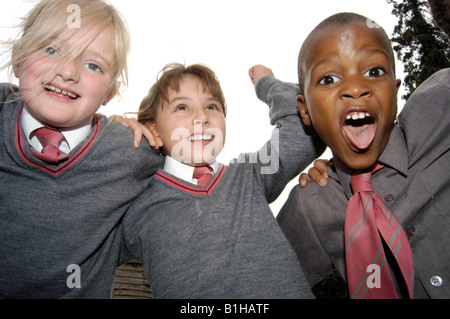 Children shouting and smiling in school in a group Stock Photo