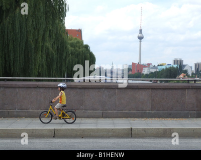 small boy riding bike on road in berlin germany