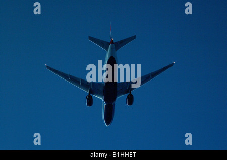 A British Airways Boeing 777 seen in twilight conditions from 1000 feet below over the North Atlantic Stock Photo