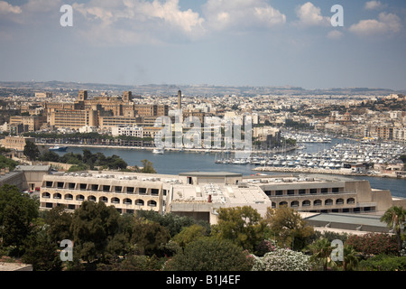 View north west from St John Counterguard across hotel and harbour to Msida hospital in Valetta or Valletta Malta Stock Photo