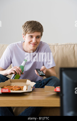 A young man watching tv Stock Photo