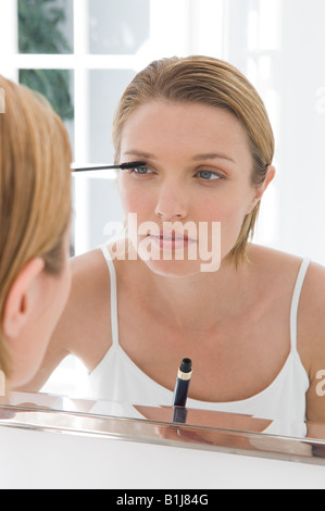 A woman applying mascara Stock Photo