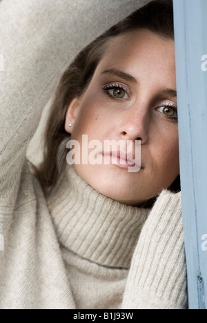 young woman wearing a turtleneck, looking seriously Stock Photo