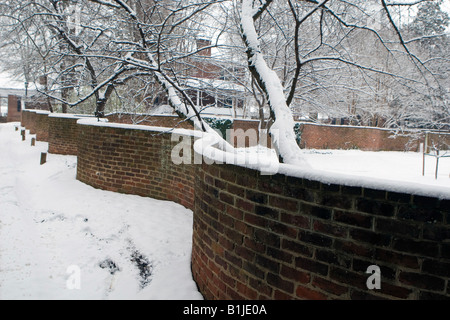 A serpentine brick wall is covered by snow during a winter storm on the Grounds of the University of Virginia in Charlottesville Virginia on January 18 2008 Stock Photo