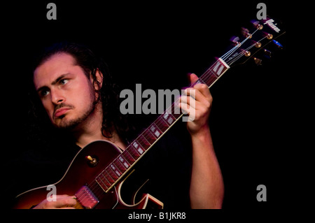 jazz guitarist playing semi acoustic electric guitar Stock Photo