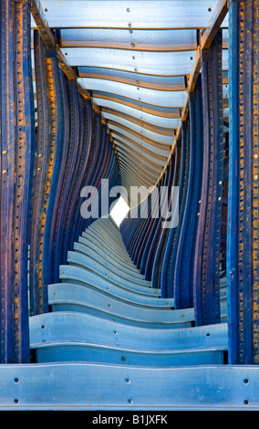Geometrical steel beams form a twisted tunnel using digital manipulation. Stock Photo