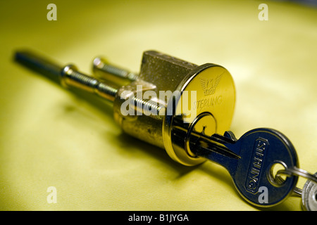 Cylinder lock and key, Cylinder key in lock, unlocking, key in lock, yale key in lock, Close Up Of Key Being Inserted Into Lock, security Stock Photo