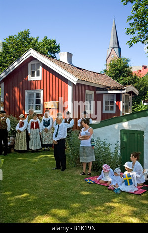 People in traditional folk dresses celebrate Swedish National Day at Öckerö Island Bohuslan West Sweden 06 Jun 2008 Stock Photo