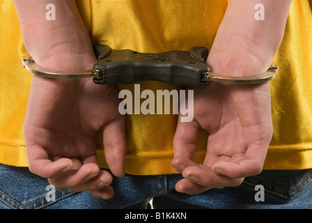 Teenage gang member in handcuffs Stock Photo