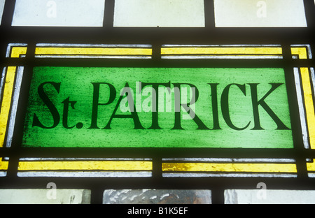 Detail of early 20th century stained glass window stating simply St PATRICK Stock Photo