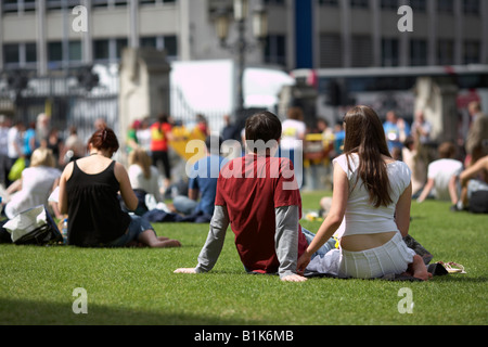 couple sitting having lunch on the grass at belfast city hall northern ireland Stock Photo