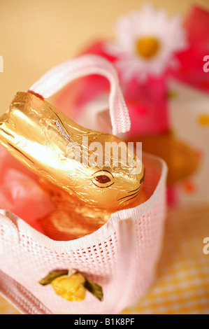 Easter basket, daisies and chocolate bunny Stock Photo