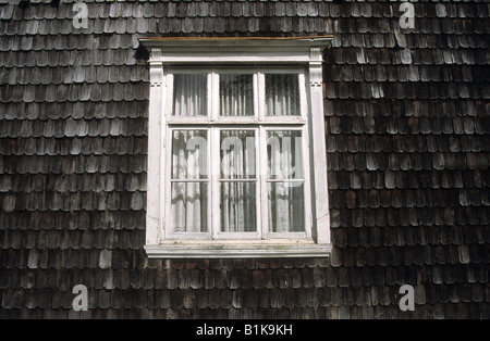 Detail of window traditional wooden house and wall shingles, Puerto Varas, Región de Los Lagos, Chile Stock Photo